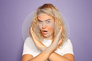 Portrait of beautiful young woman rejecting something on color background