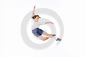 Portrait of beautiful young woman in retro outfit dancing, posing isolated over white studio background