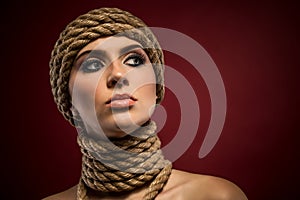 Portrait of a beautiful young woman with ropes