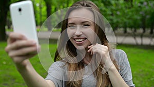 Portrait of a beautiful young woman, selfie in the street a smartphone