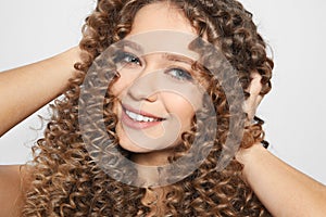 Portrait of beautiful young woman with shiny hair on color background, closeup