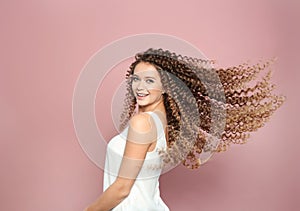 Portrait of beautiful young woman with shiny wavy hair