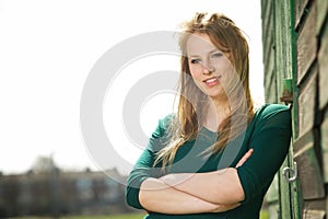 Portrait of a beautiful young woman smiling outside