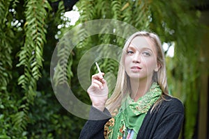 Portrait of a beautiful young woman smoking