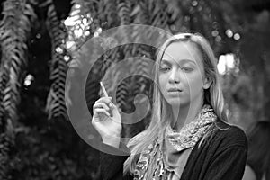 Portrait of a beautiful young woman smoking