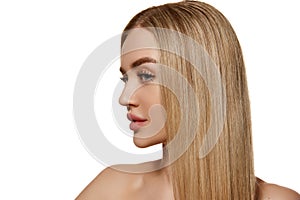 Portrait of beautiful young woman with smooth blonde hair and well-kept skin isolated against white studio background