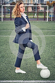 Portrait of beautiful young woman soccer player at stadium with ball