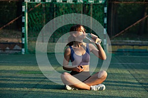 Portrait of a beautiful young woman in sportswear outdoors. Sport fitness model caucasian ethnicity training.