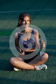 Portrait of a beautiful young woman in sportswear outdoors. Sport fitness model caucasian ethnicity training.