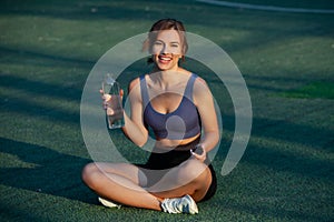 Portrait of a beautiful young woman in sportswear outdoors. Sport fitness model caucasian ethnicity training.