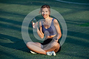 Portrait of a beautiful young woman in sportswear outdoors. Sport fitness model caucasian ethnicity training.