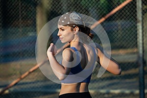 Portrait of a beautiful young woman in sportswear outdoors. Sport fitness model caucasian ethnicity training.