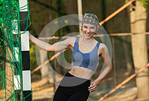 Portrait of a beautiful young woman in sportswear outdoors. Sport fitness model caucasian ethnicity training.