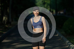 Portrait of a beautiful young woman in sportswear outdoors. Sport fitness model caucasian ethnicity training.