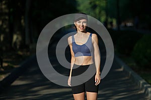 Portrait of a beautiful young woman in sportswear outdoors. Sport fitness model caucasian ethnicity training.