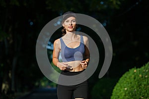 Portrait of a beautiful young woman in sportswear outdoors. Sport fitness model caucasian ethnicity training.