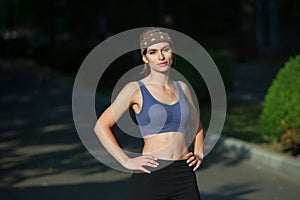 Portrait of a beautiful young woman in sportswear outdoors. Sport fitness model caucasian ethnicity training.