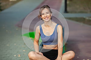 Portrait of a beautiful young woman in sportswear outdoors. Sport fitness model caucasian ethnicity training outdoor.