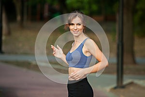 Portrait of a beautiful young woman in sportswear outdoors. Sport fitness model caucasian ethnicity training outdoor.