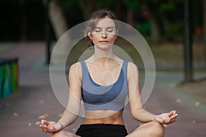 Portrait of a beautiful young woman in sportswear outdoors. Sport fitness model caucasian ethnicity training outdoor.