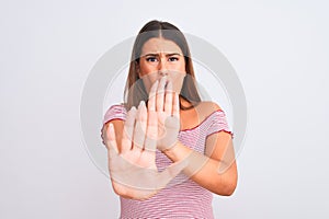Portrait of beautiful young woman standing over isolated white background afraid and terrified with fear expression stop gesture