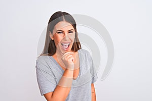 Portrait of beautiful young woman standing over isolated white background looking confident at the camera smiling with crossed