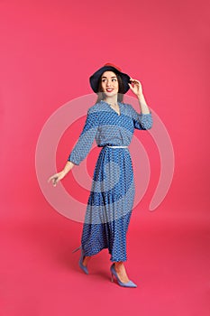 Portrait of beautiful young woman in stylish dress