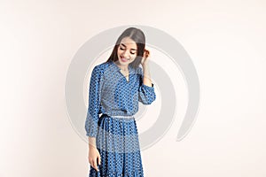 Portrait of beautiful young woman in stylish dress