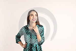 Portrait of beautiful young woman in stylish dress on white background.