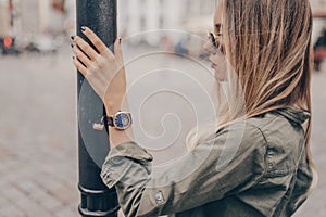 Portrait of beautiful young woman with stylish watch