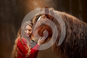 Portrait of a beautiful young woman with Tinker horse