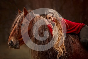 Portrait of a beautiful young woman with Tinker horse