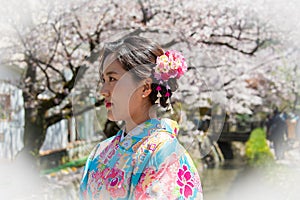 Portrait of a beautiful young woman in traditional Japanese Kimono with Cherry Blossom