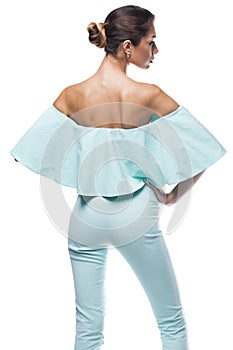 Portrait of a beautiful young woman in turquoise tight clothes