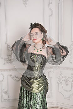 Portrait of Beautiful young woman wearing green medieval vintage Victorian Style dress