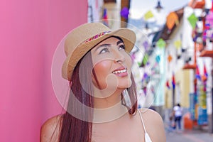 Portrait of beautiful young woman wearing a panama hat at historical center of old town Quito in northern Ecuador in the photo