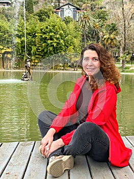 Portrait of beautiful young woman wearing red jacket outdoors