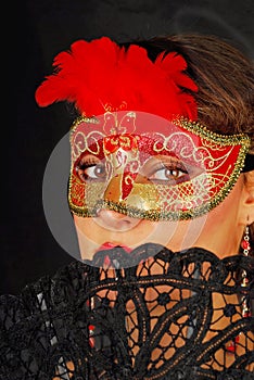 Portrait of beautiful young woman wearing red mask