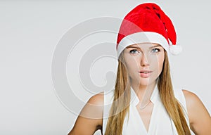 Portrait of beautiful young woman wearing santa claus hat