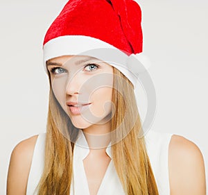 Portrait of beautiful young woman wearing santa claus hat