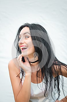 Portrait of a beautiful young woman in a white T-shirt with black hair. joy and laughter degenerate. positive emotions. Life style