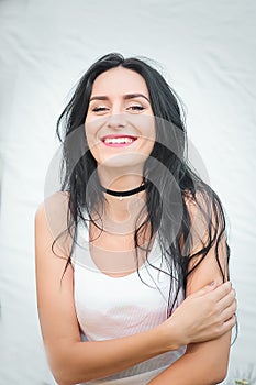 Portrait of a beautiful young woman in a white T-shirt with black hair. joy and laughter degenerate. positive emotions. Life style