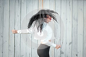 Portrait of a beautiful young woman in a white T-shirt with black hair. joy and laughter degenerate. positive emotions. Life style