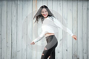 Portrait of a beautiful young woman in a white T-shirt with black hair. joy and laughter degenerate. positive emotions. Life style