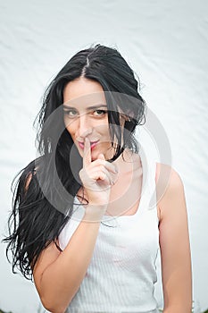 Portrait of a beautiful young woman in a white T-shirt with black hair. joy and laughter degenerate. positive emotions. Life style