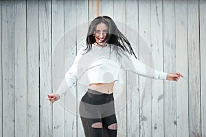 Portrait of a beautiful young woman in a white T-shirt with black hair. joy and laughter degenerate. positive emotions. Life style