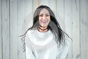 Portrait of a beautiful young woman in a white T-shirt with black hair. joy and laughter degenerate. positive emotions. Life style