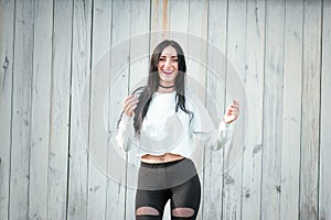 Portrait of a beautiful young woman in a white T-shirt with black hair. joy and laughter degenerate. positive emotions. Life style