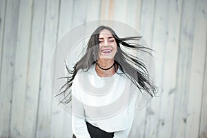 Portrait of a beautiful young woman in a white T-shirt with black hair. joy and laughter degenerate. positive emotions. Life style