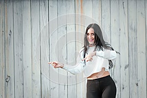 Portrait of a beautiful young woman in a white T-shirt with black hair. joy and laughter degenerate. positive emotions. Life style